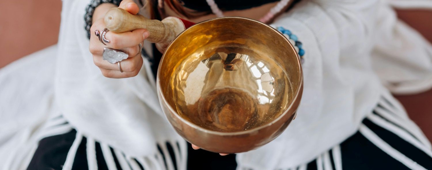 woman holding singing bowl